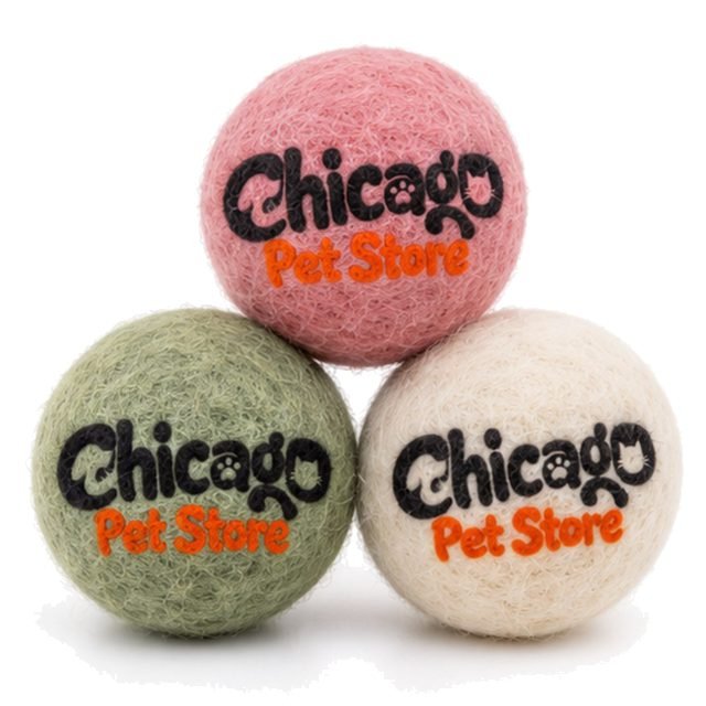 Set of three felt wool cat balls in pink, sage green and cream